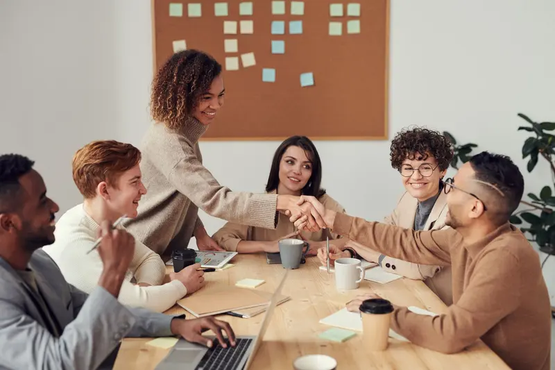 Team working together at a table with laptops